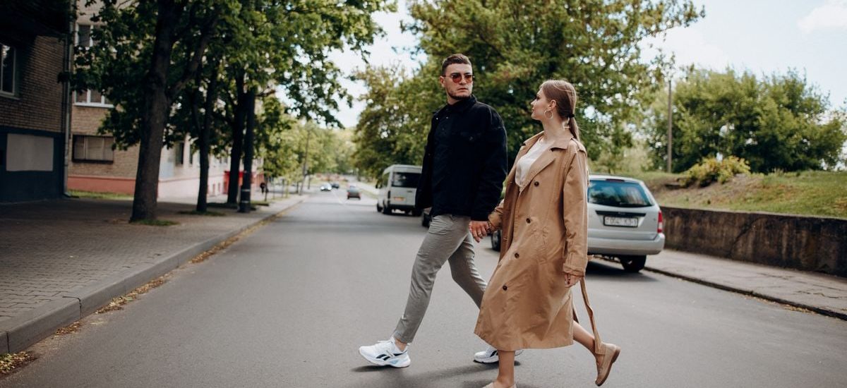 A romantic couple strolls hand in hand down a peaceful city street, embodying love and connection.